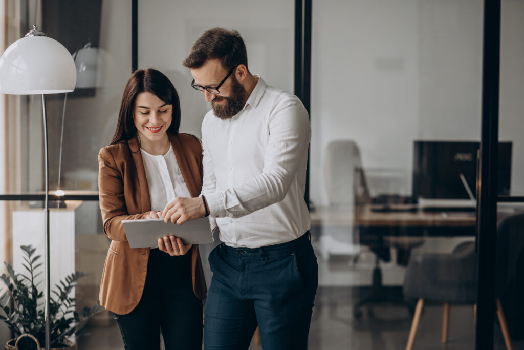 Two Business Partners Working In Office - Hold